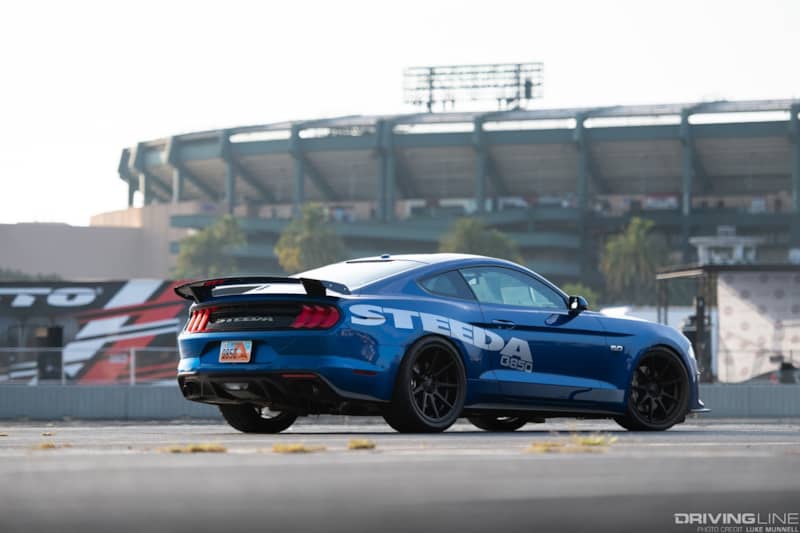 Ford Mustang Steeda blue in parking lot of sports stadium