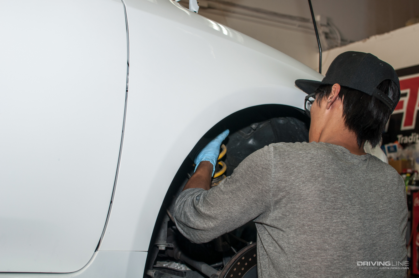 Man working on a car's suspension