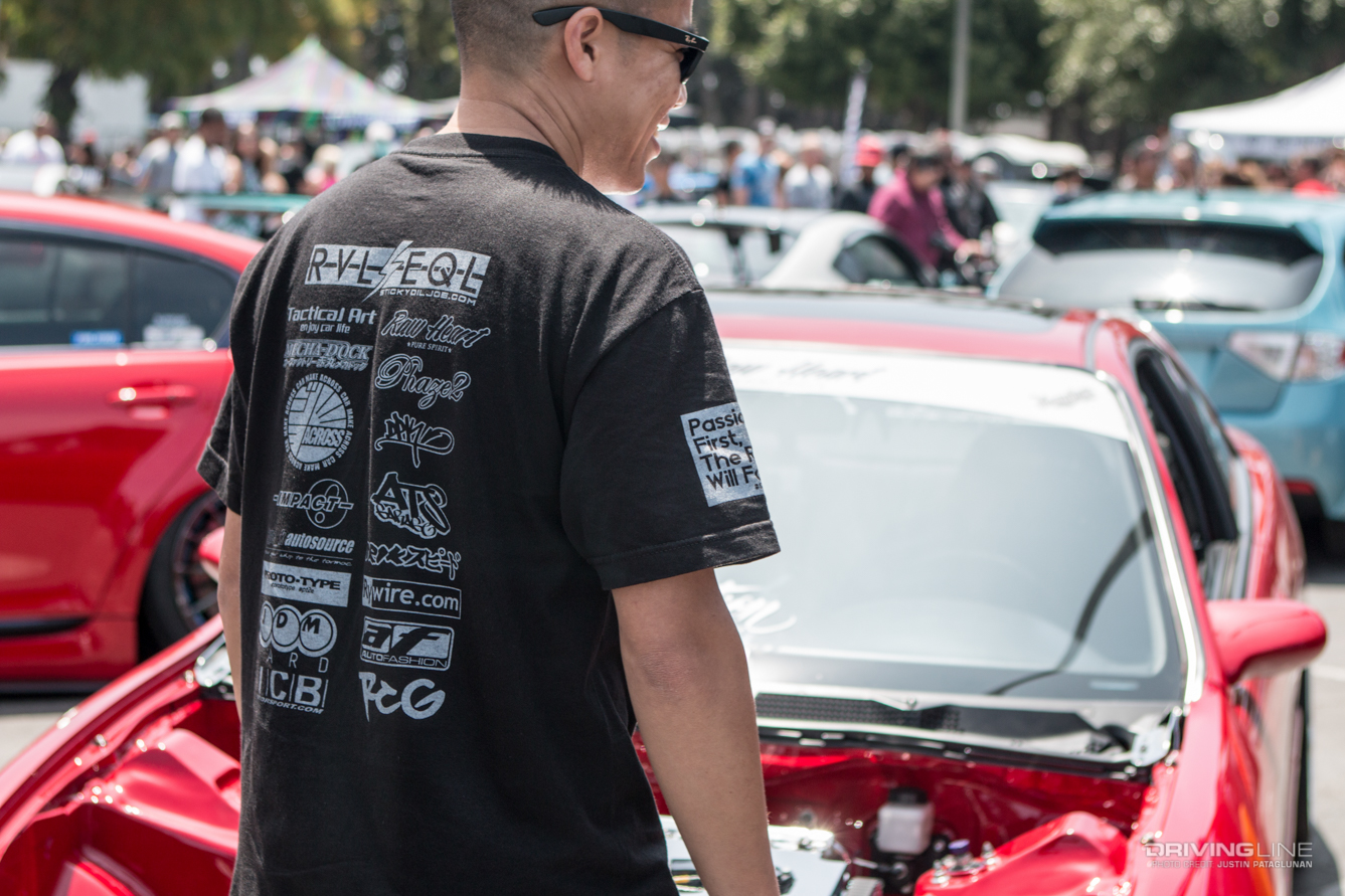 Man standing in front of a car at a show