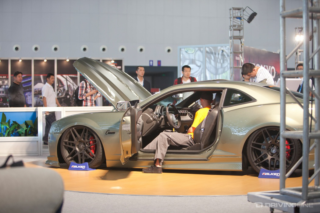 Man sitting in a Camaro at a car show