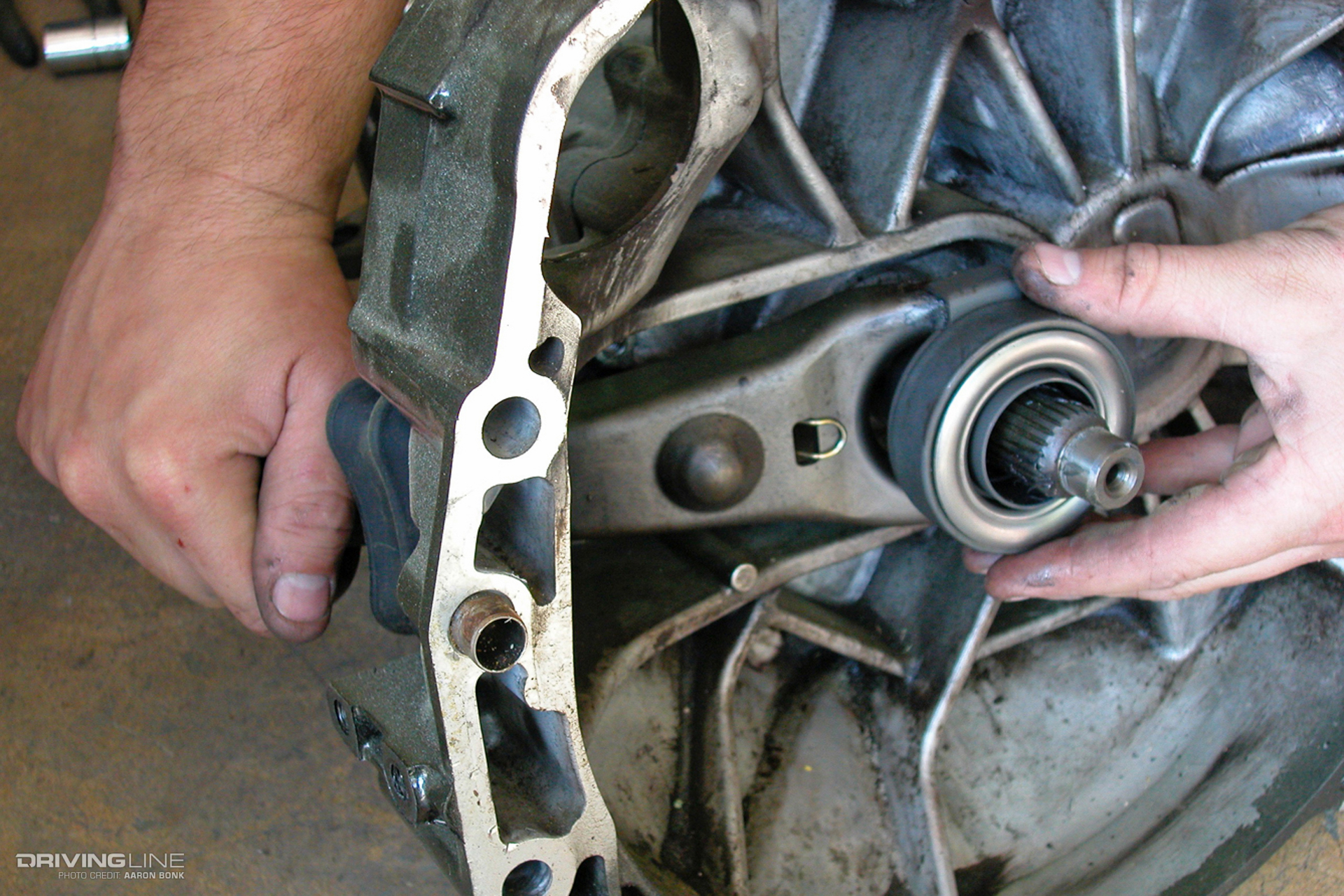 Hands holding a car part