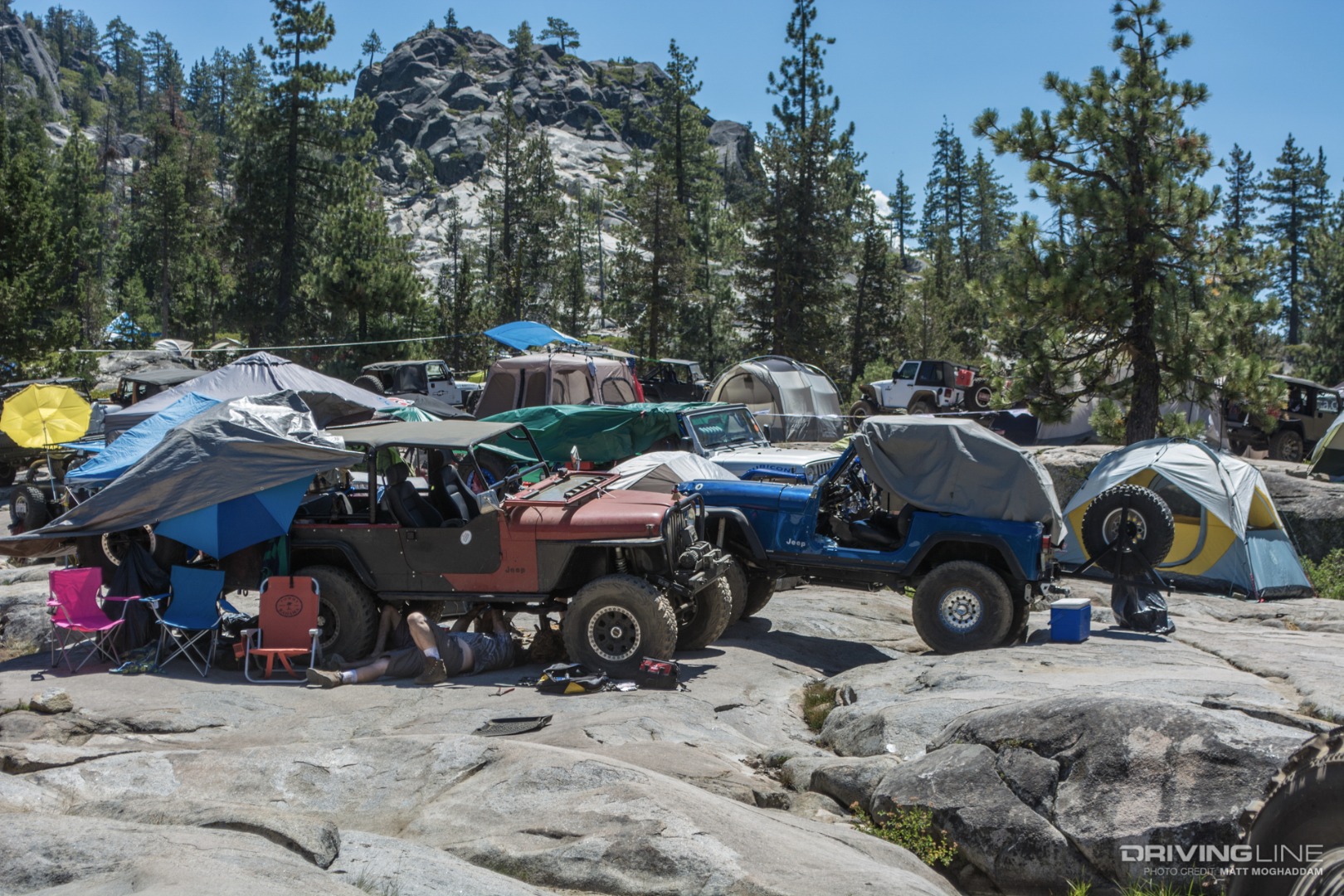 Various Jeeps sprawled along the granite banks of the Rubicon river