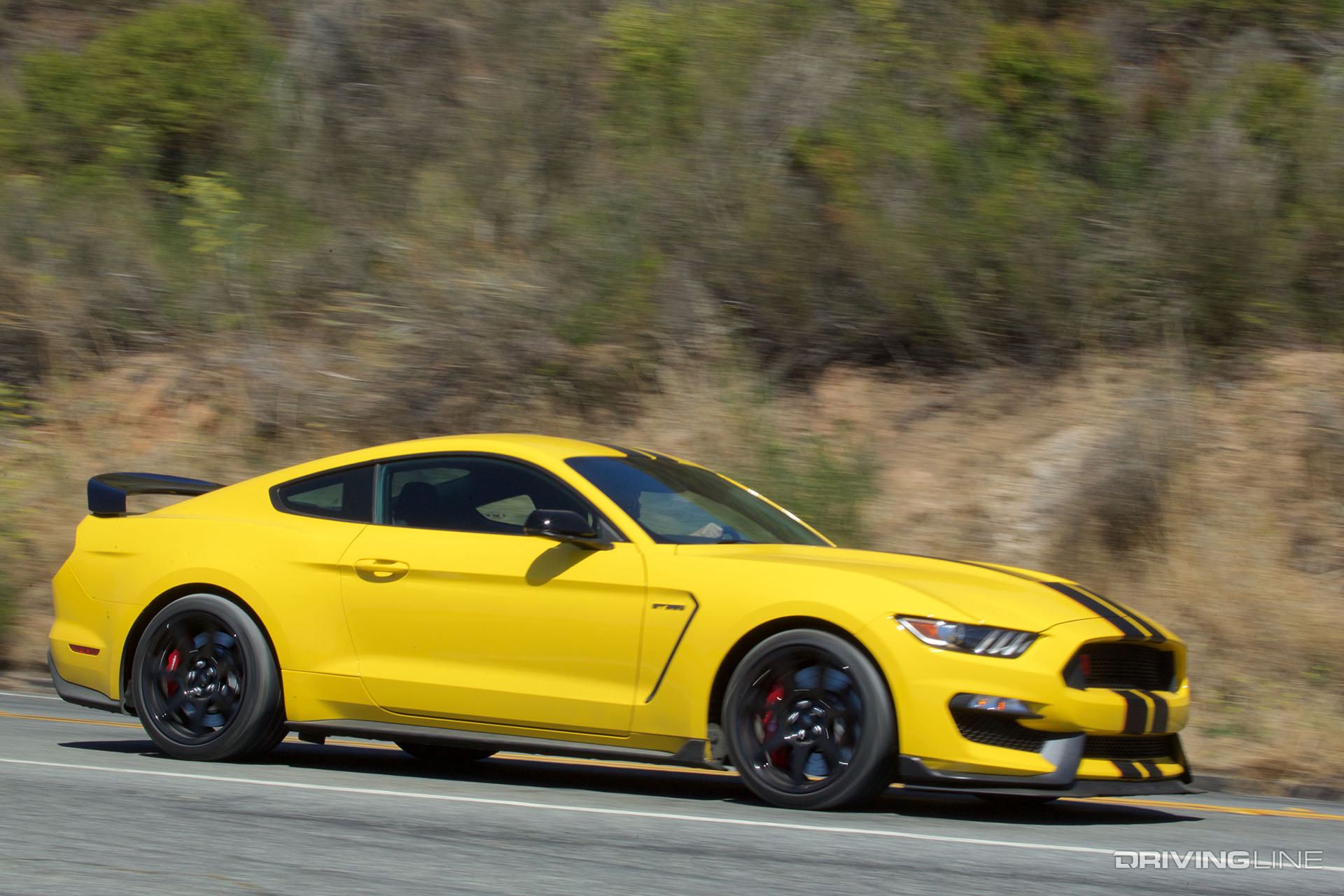 Yellow Ford Mustang with black racing stripes