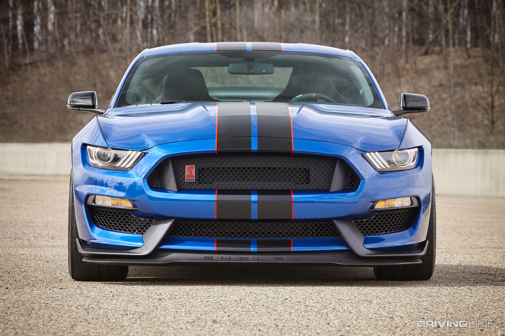 Blue Ford Mustang with black racing stripes with orange accents