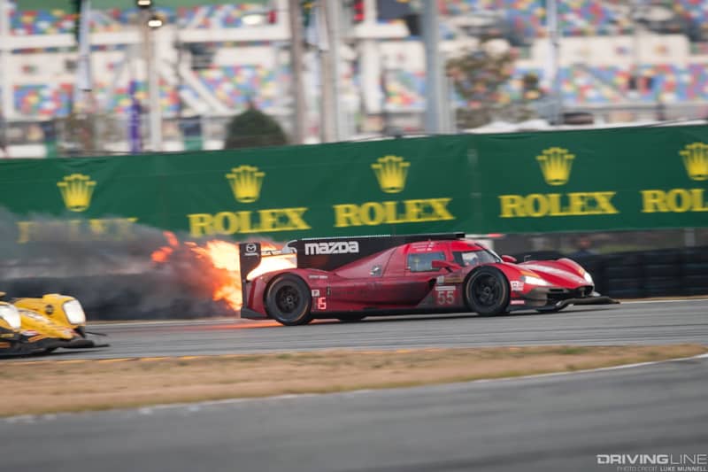 Mazda Team Joest at Rolex 24 Hours of Daytona RT24-P no. 55 car on fire rounding international horseshoe Turn 3