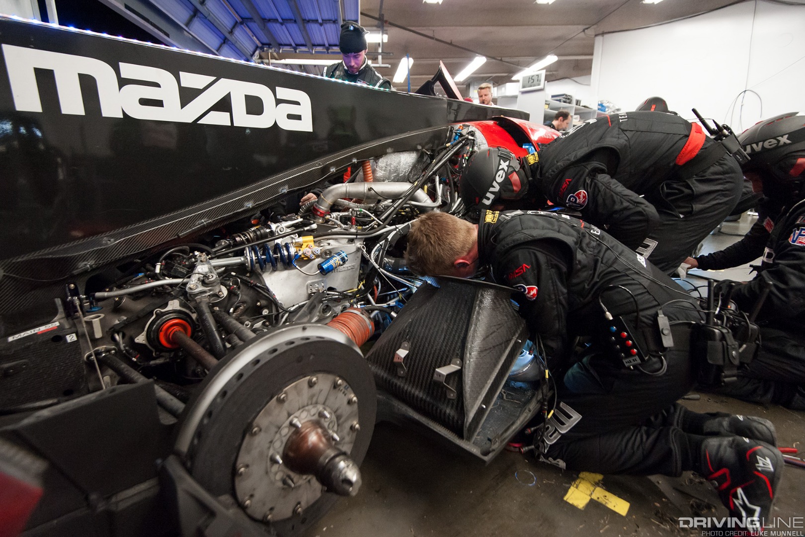 Mazda Team Joest pits at Rolex 24 Hours of Daytona RT24-P troubleshooting wrenching