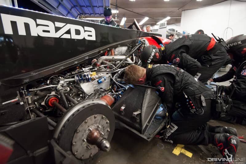 Mazda Team Joest pits at Rolex 24 Hours of Daytona RT24-P troubleshooting wrenching