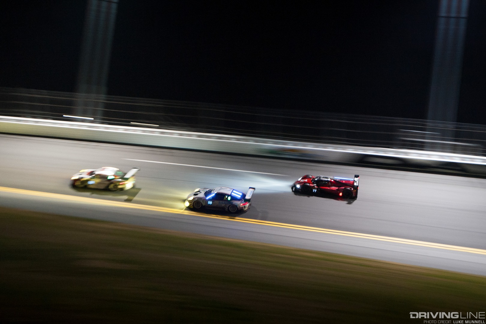 Mazda Team Joest at Rolex 24 Hours of Daytona RT24-P racing on the bank at night slow shutter pan