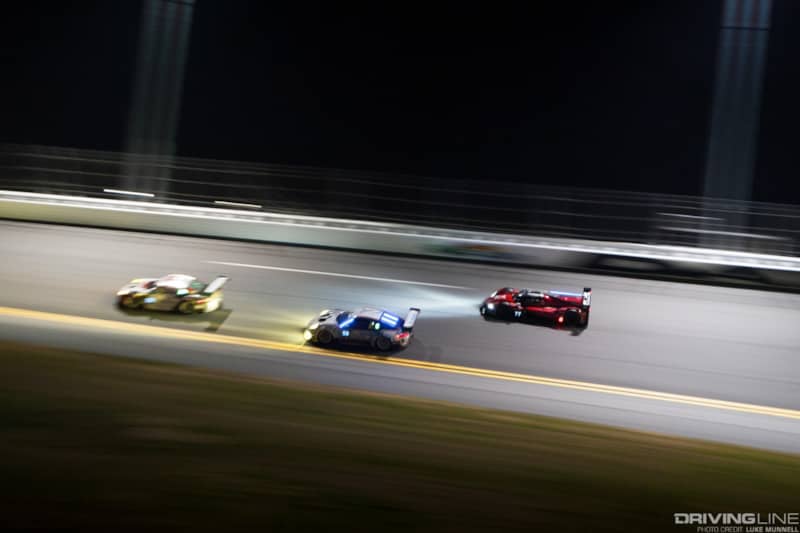 Mazda Team Joest at Rolex 24 Hours of Daytona RT24-P racing on the bank at night slow shutter pan