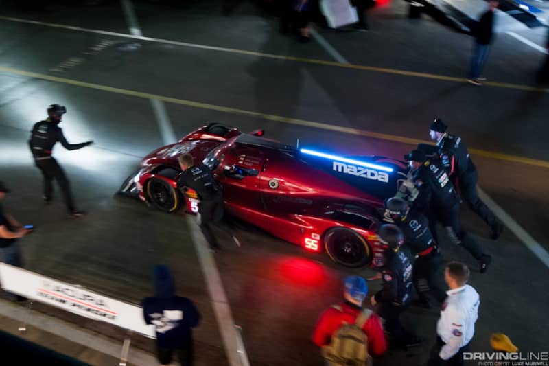 Mazda Team Joest pits at Rolex 24 Hours of Daytona RT24-P leaving the pits overhead pan blur being pushed