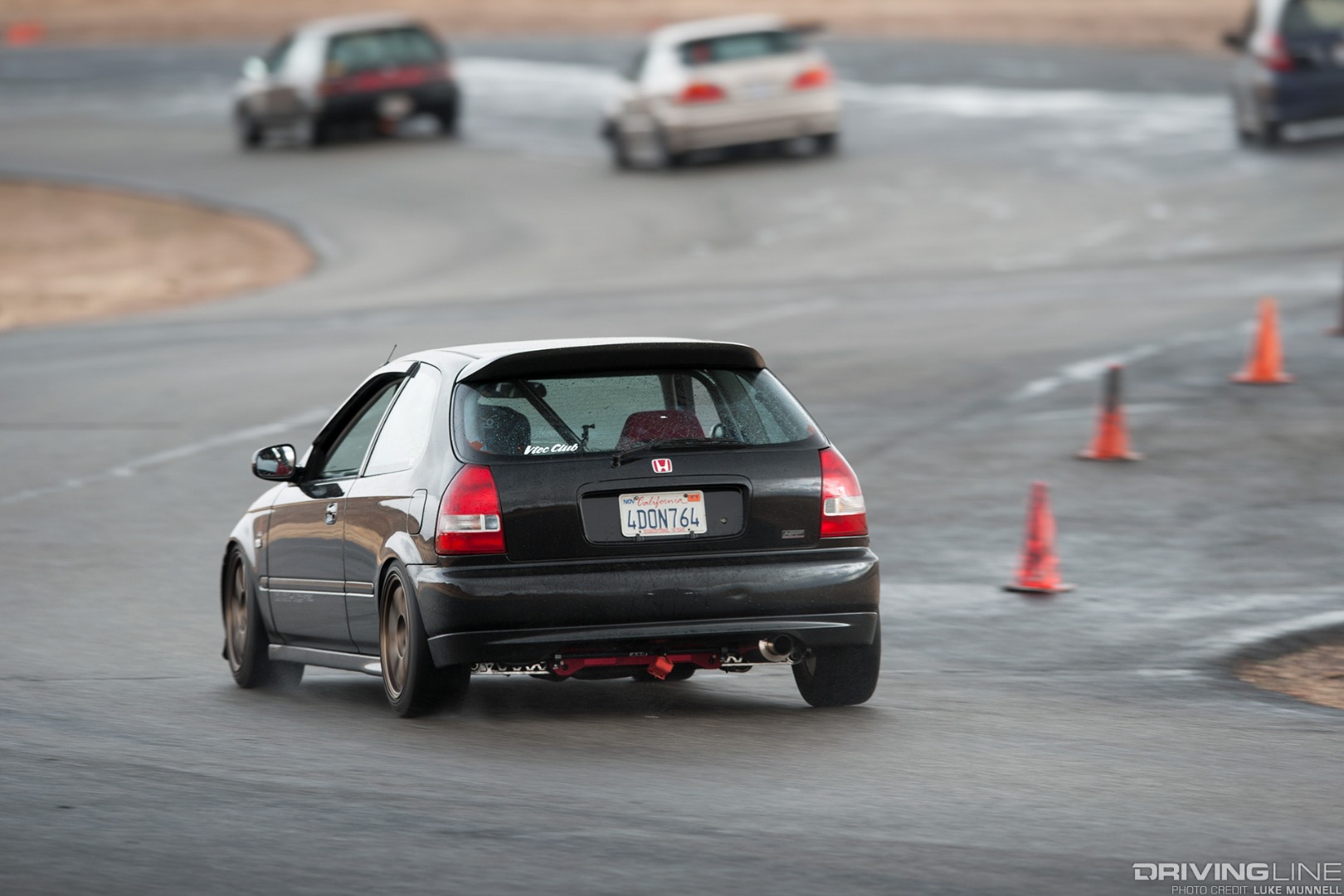 VTEC Club USA rd. 1 Streets of Willow Springs black EK Honda Civic hatchback racing in the rain rear shot