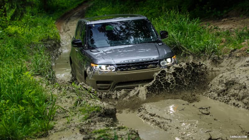 Range Rover Driving Through a Muddy Wash