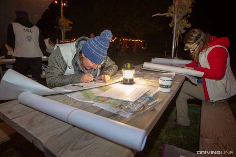 Elise Bent and other Rebelles plotting checkpoints on topo maps