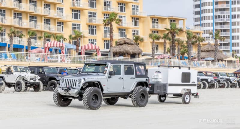 Jeeps in front of a hotel next to the beach at Jeep Beach