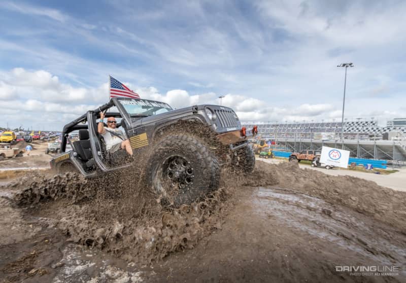 Jeep driving through the mud in the Daytona Speedway infield at Jeep Beach