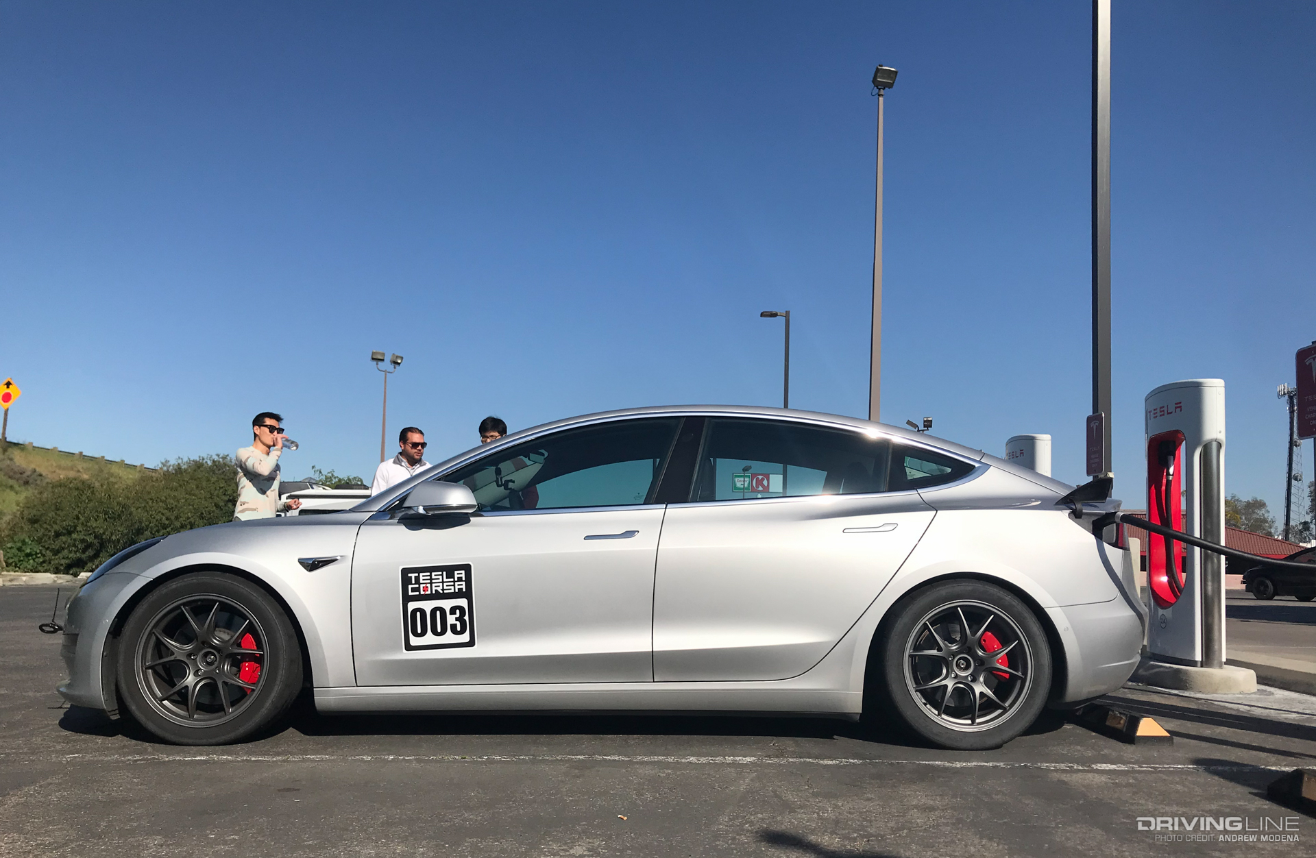 Silver lowered Tesla Model 3 Nitto NT05 Supercharger Charging