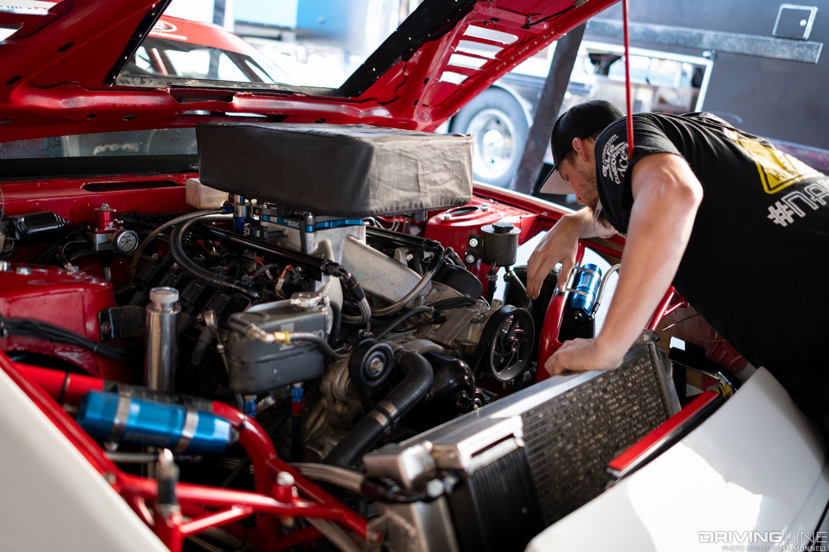 Travis Reeder head in the engine bay with V8 engine