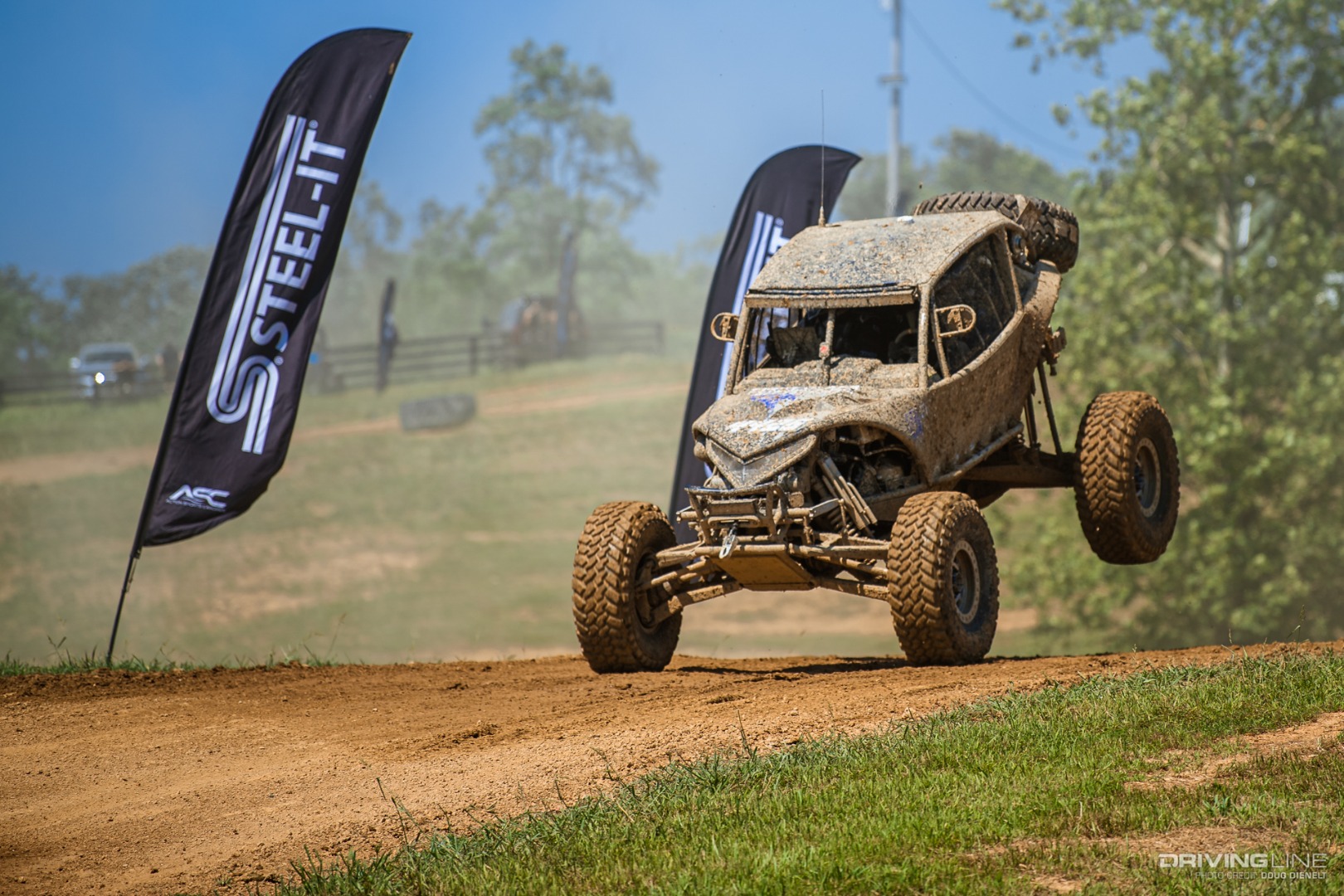 Muddy car landing from a jump at Kentucky