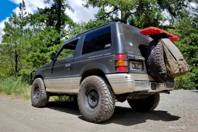 Mitsubishi Pajero with Nitto Ridge Grapplers and fifteen52 Analog HD wheels, complete with Maxtrax and a Trasharoo container