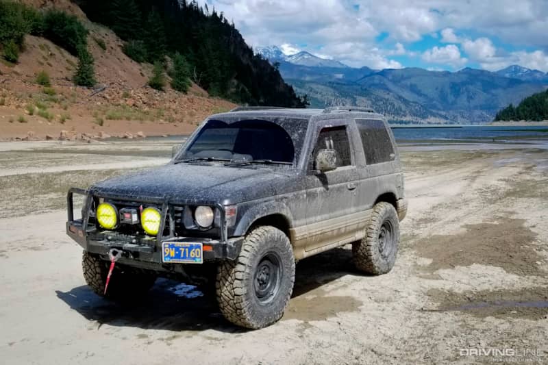 Mitsubishi Pajero with Nitto Ridge Grapplers and fifteen52 Analog HD wheels, after successfully driving through a deep muddy lake in Minto, Canada