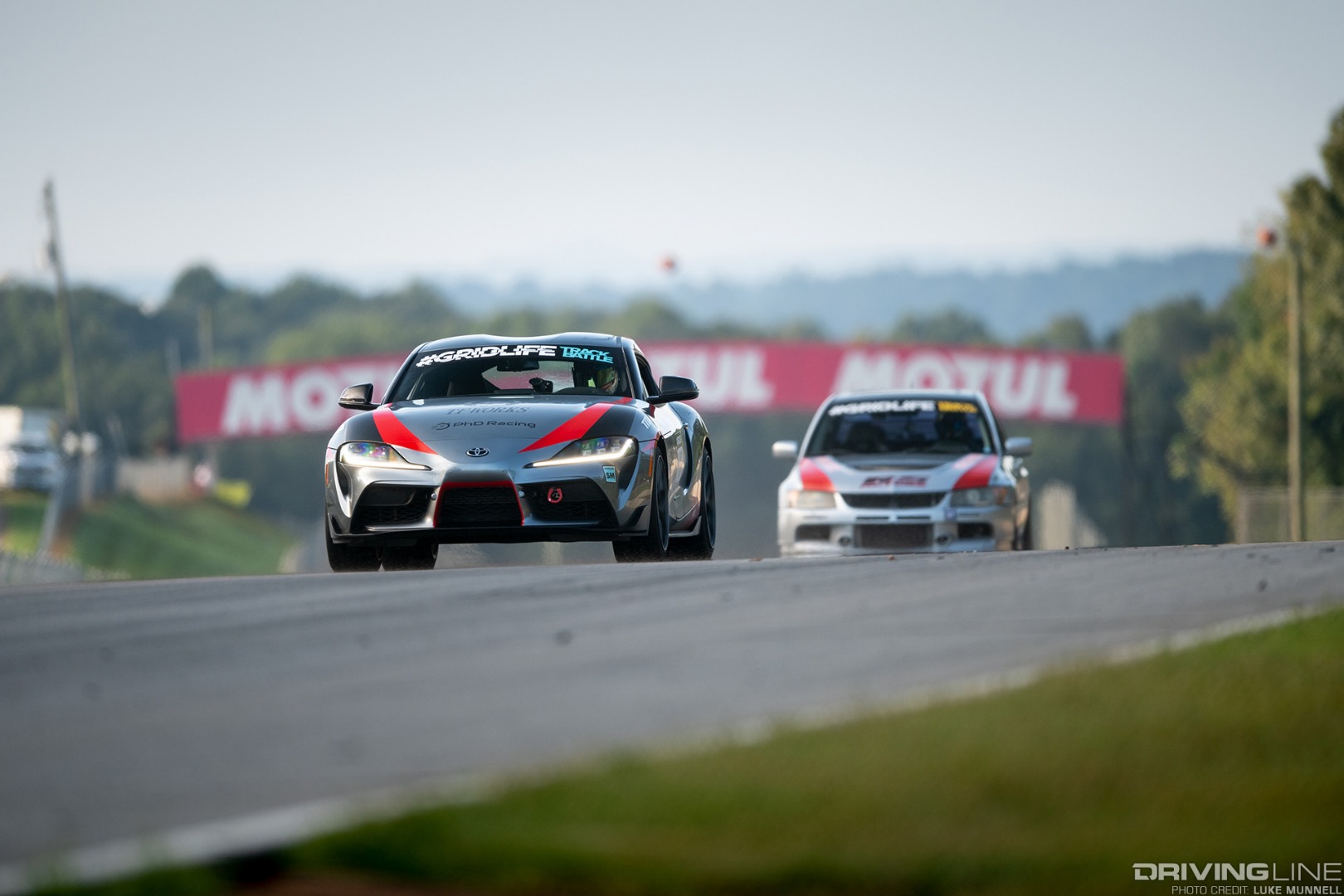 Gridlife South Road Atlanta Jackie Ding GR Toyota Supra leading Mitsubishi EVO IX