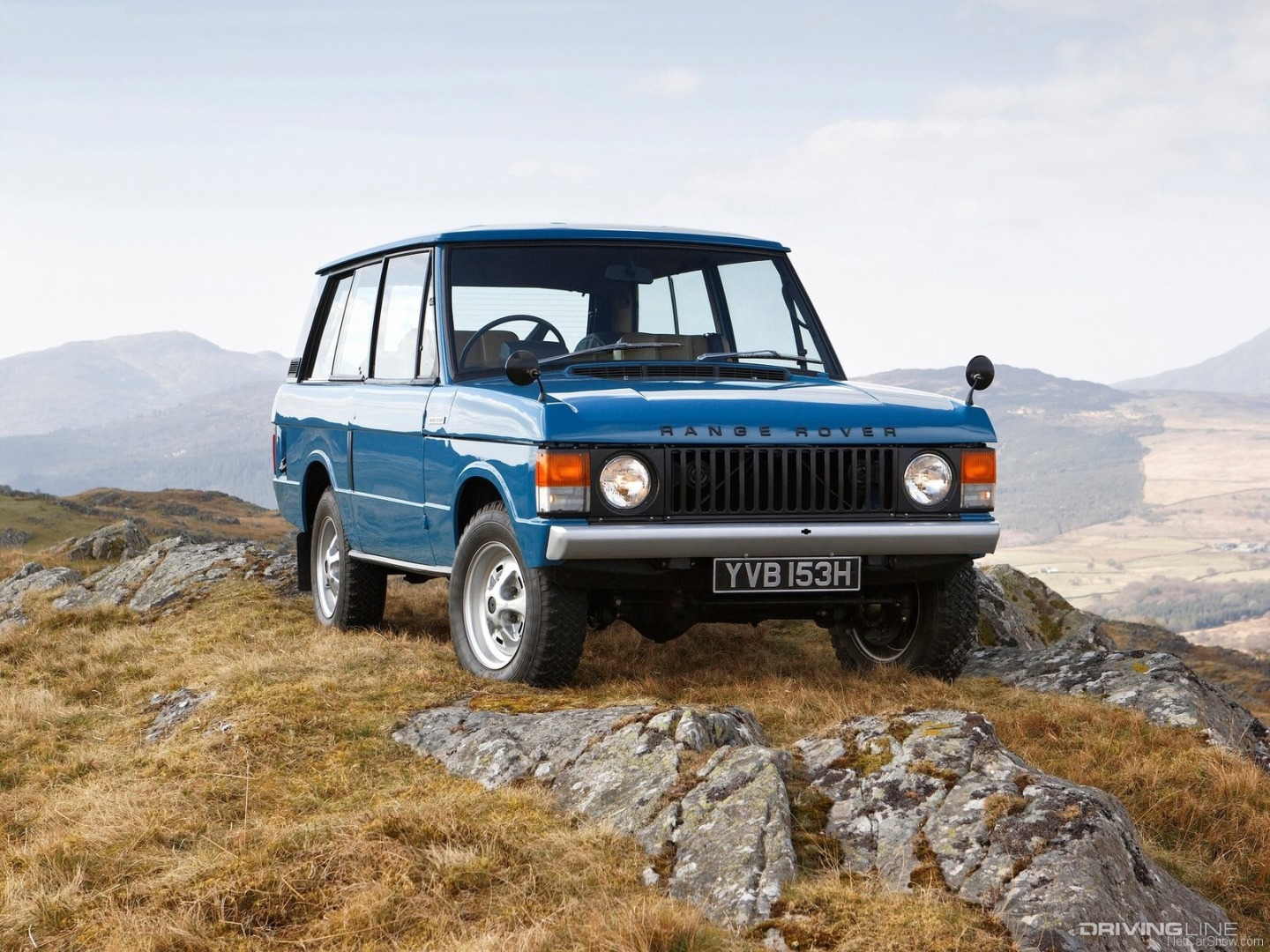 Blue Land Rover Range Rover Classic on top of mountain.