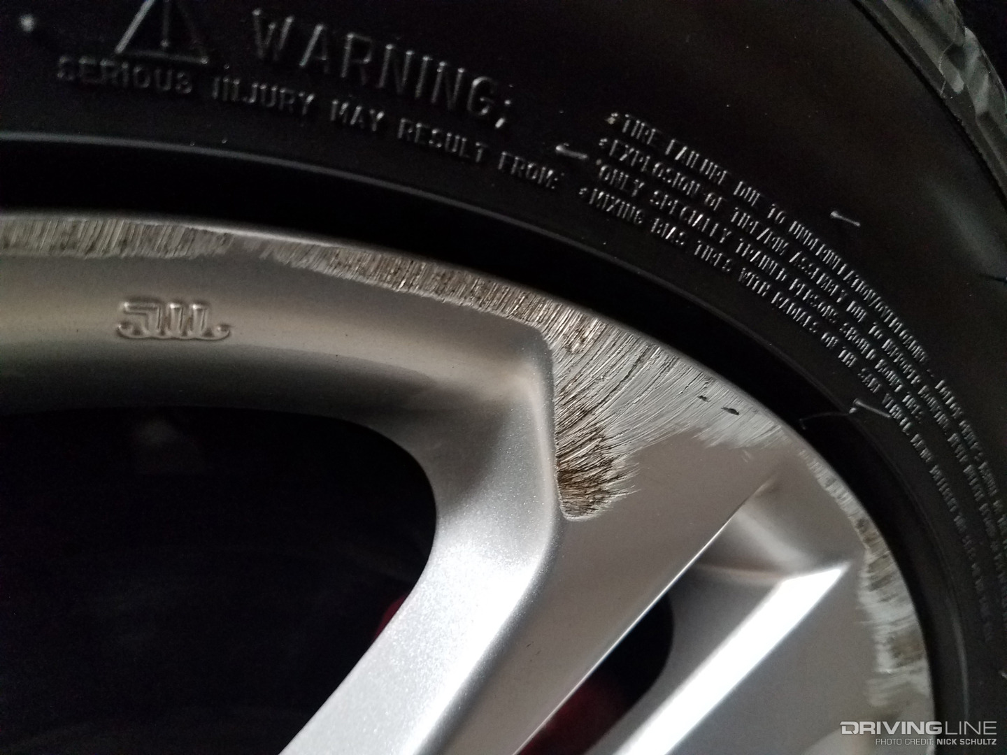 Scuffed, painted, spoked wheel damage