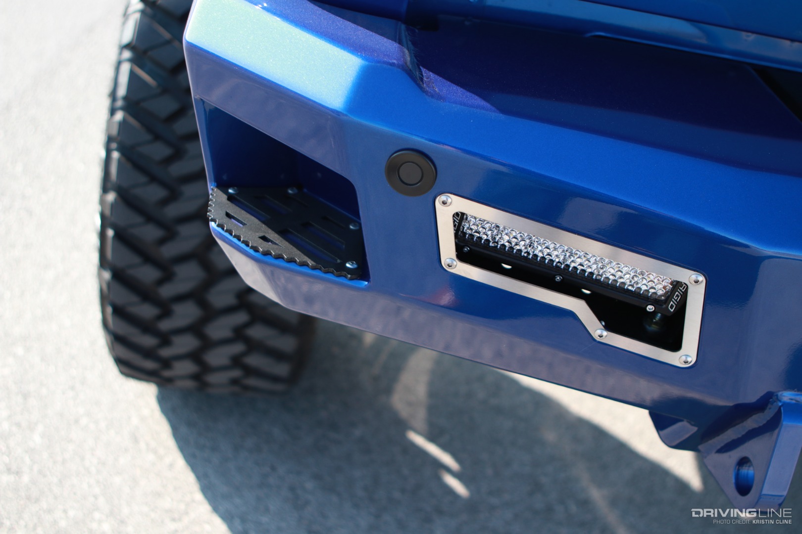Step and LED light on the rear bumper of a lifted Ram 3500