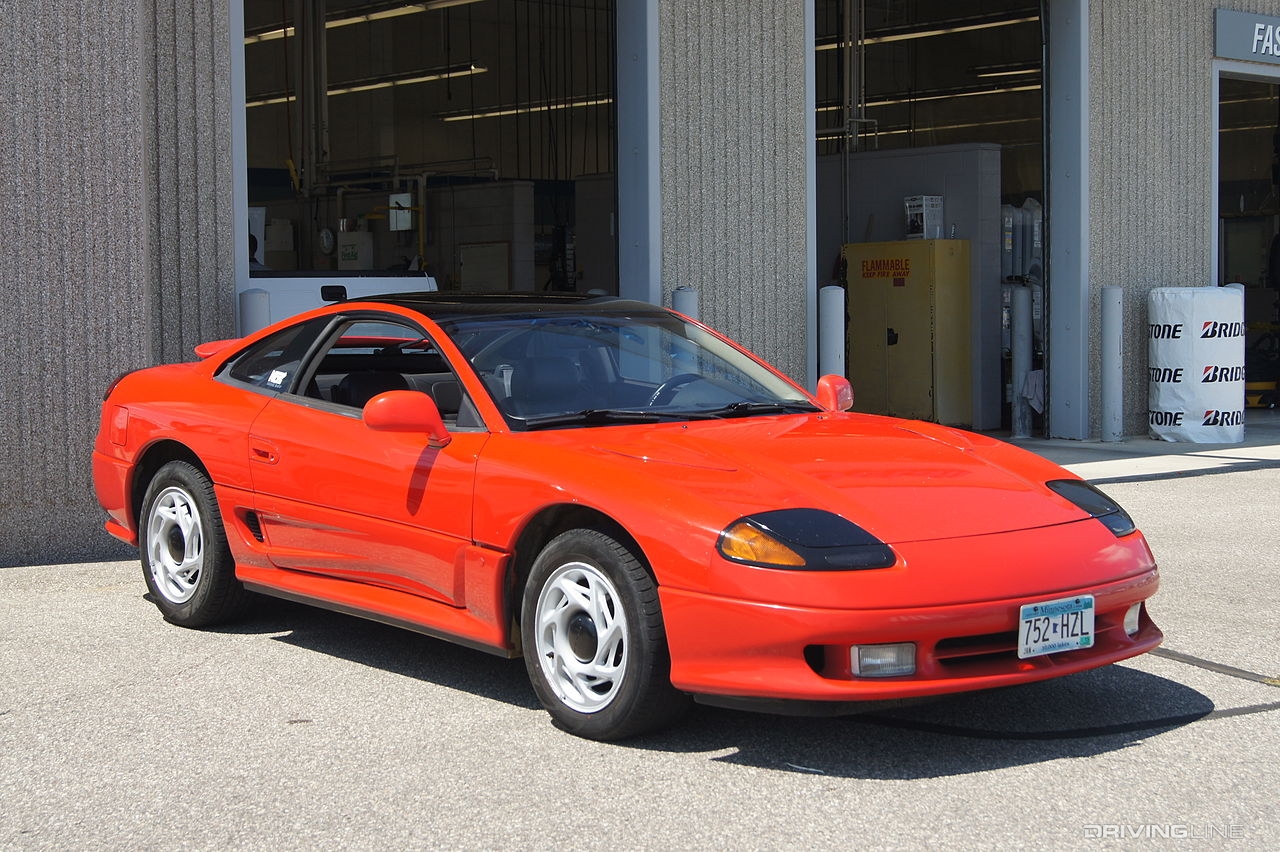 Dodge Stealth R/T in red in front of garage