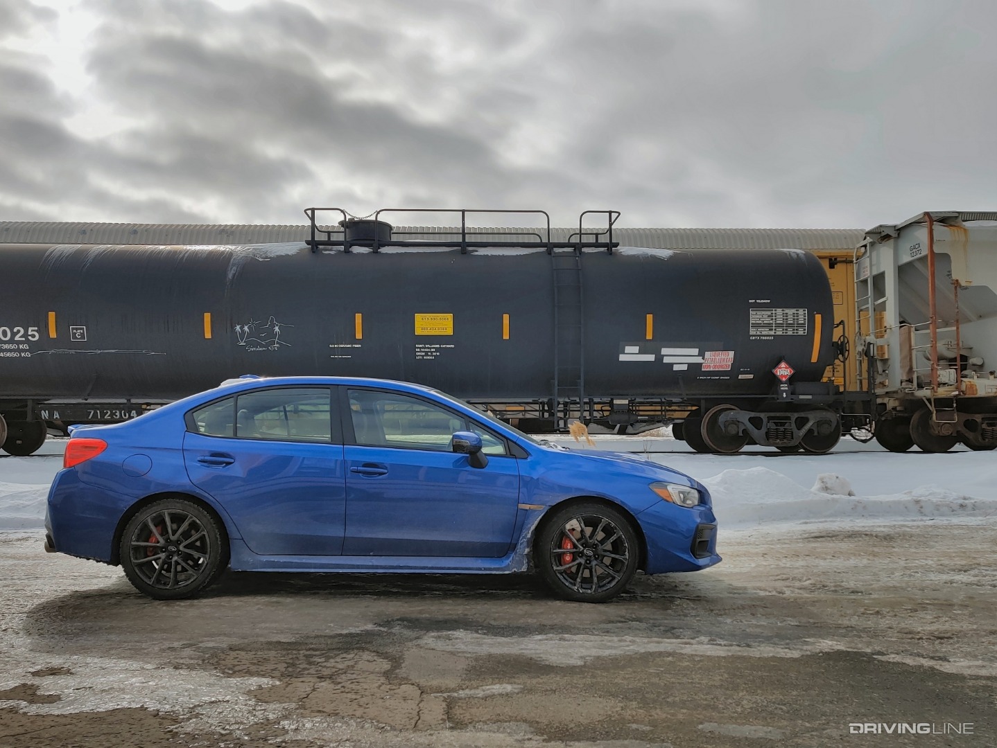 2020 Subaru WRX profile in front of trains