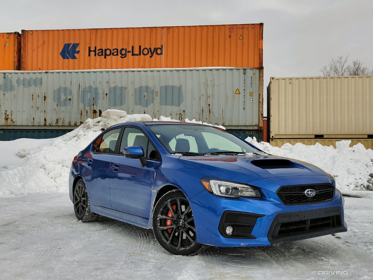 2020 Subaru WRX blue in front of cargo containers
