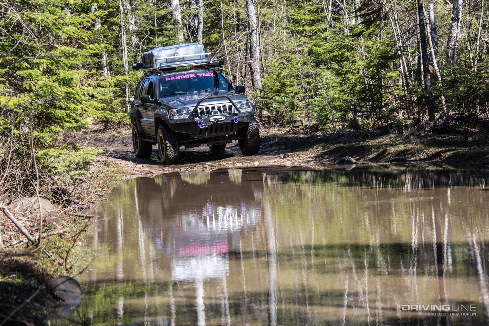 Jeep WJ on Drummond Island navigating a deep water obstacle