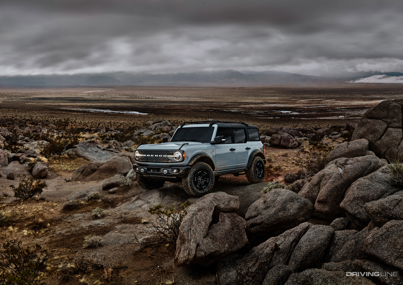 Blue Bronco 4 door on rocks