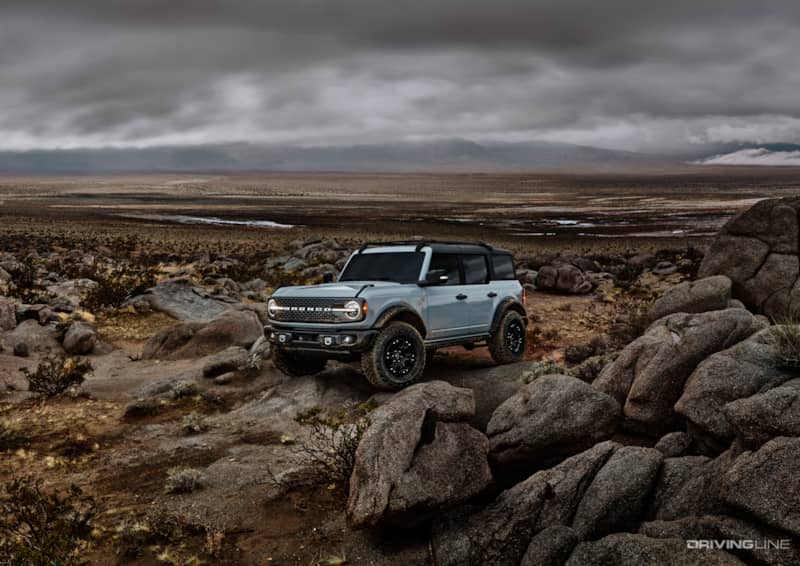 Blue Bronco 4 door on rocks