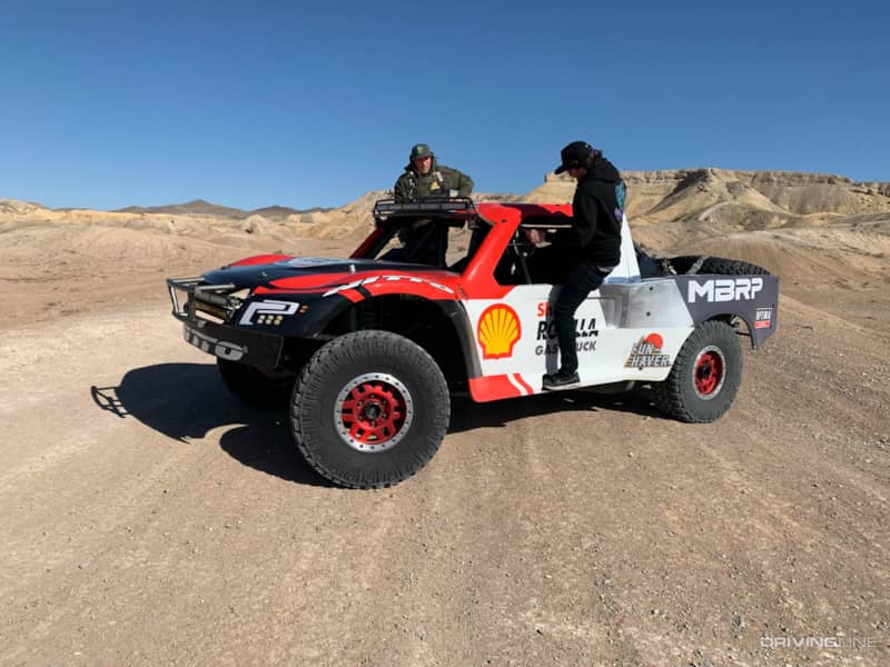 Chelsea getting behind the wheel of a desert spec racing truck with Nitto Trail Grappler tires