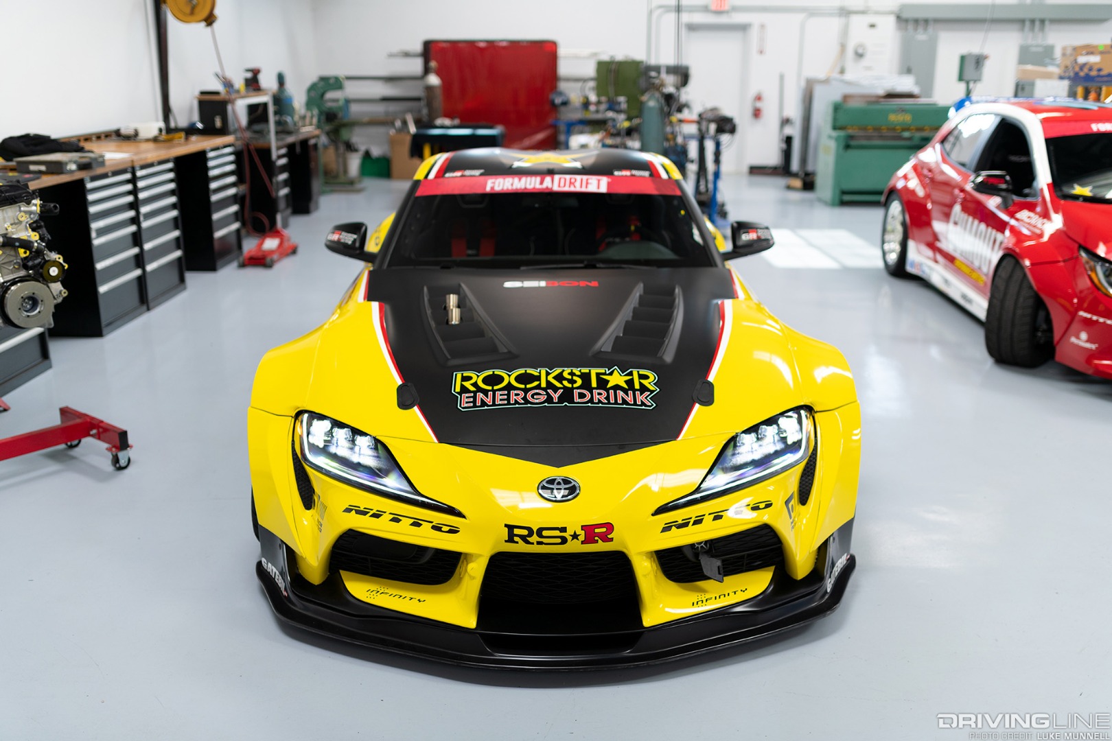 A seibon Carbon Fiber hood is secured with Aerocatch hood pins