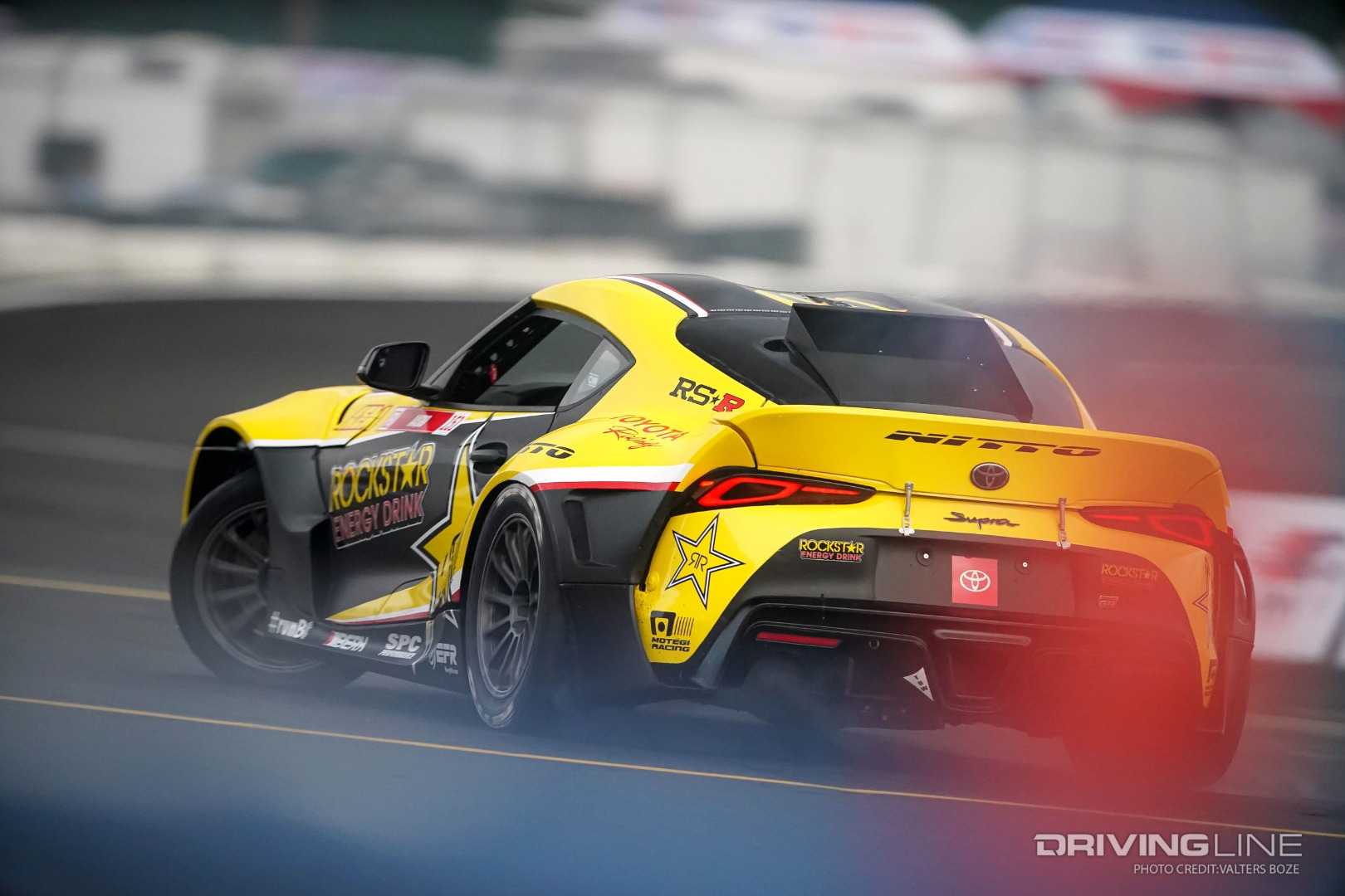 Fredric Aasbo slides his Toyota GR Supra across a wet track at Evergreen Speedway