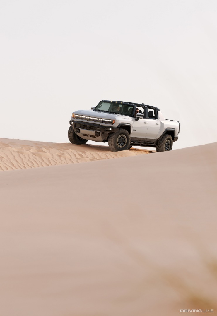 Hummer EV Driver Front 3/4 On Sand Dune From Afar