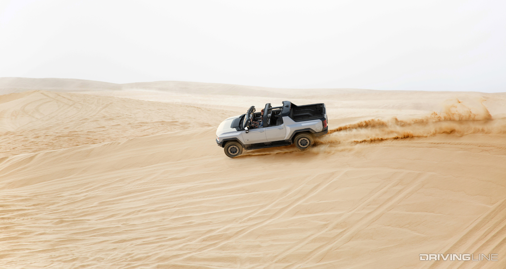 Hummer EV Side Profile Driving On Sand Dune With Sky Panels Removed