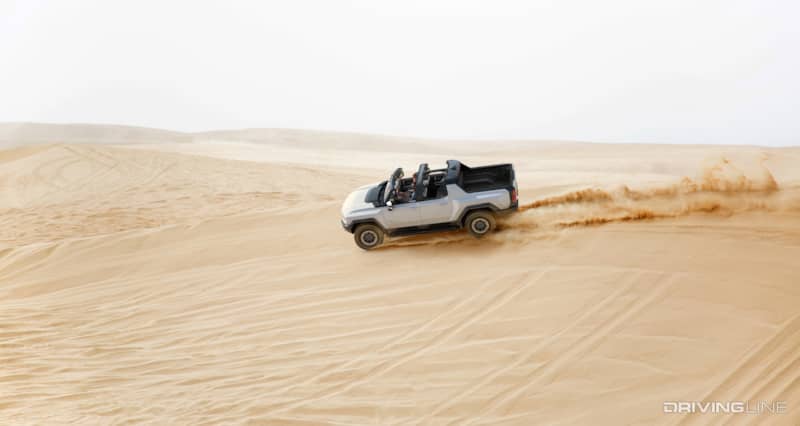 Hummer EV Side Profile Driving On Sand Dune With Sky Panels Removed