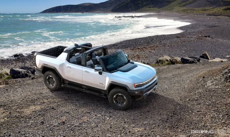Hummer EV Front 3/4 With Sky Panels Off On Beach From Passenger High