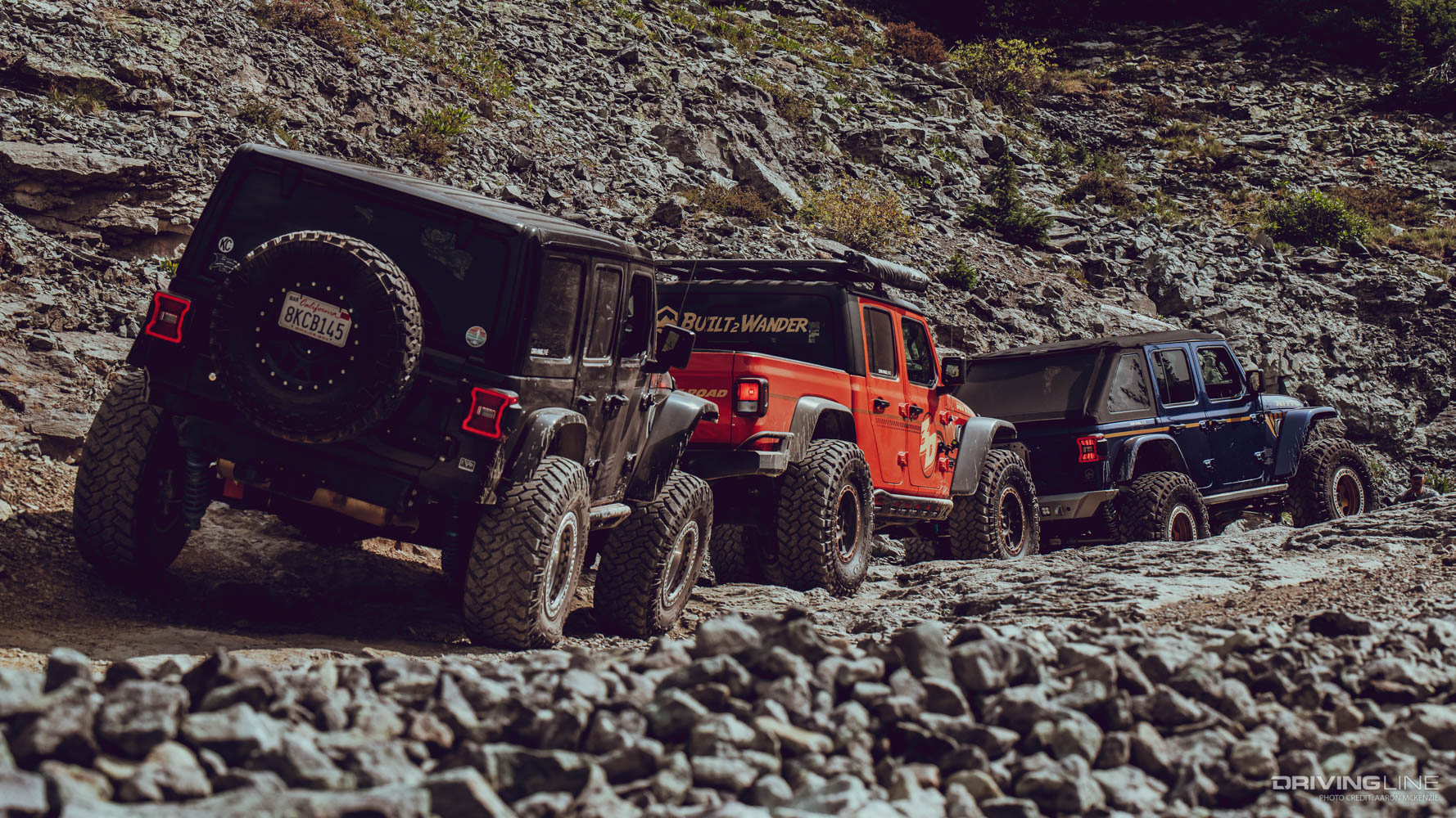 Three jeeps traversing rocky terrain on imogene pass