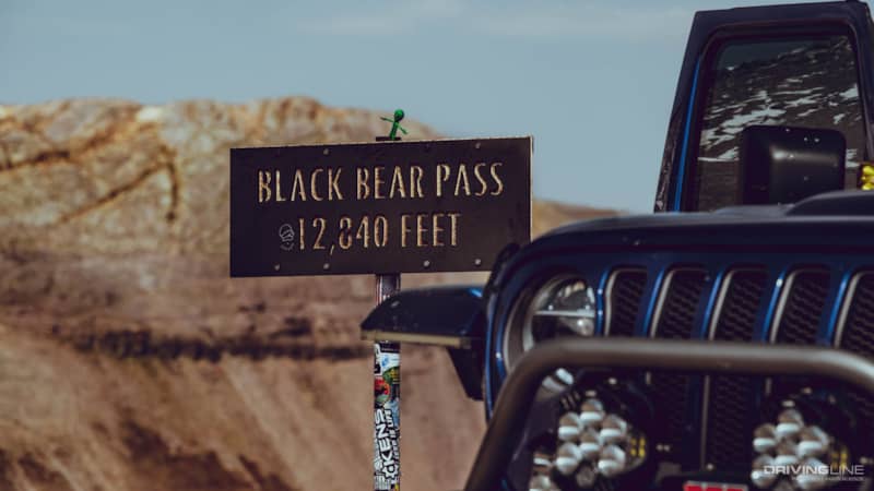 Black Bear Pass Elevation sign with a Jeep