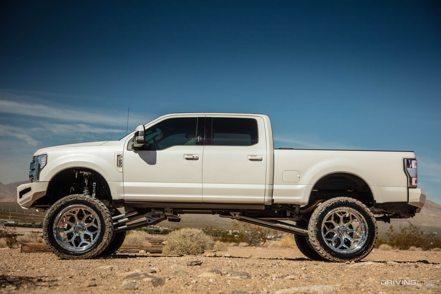 driver side profile of White lifted 2017 Ford Super Duty Truck