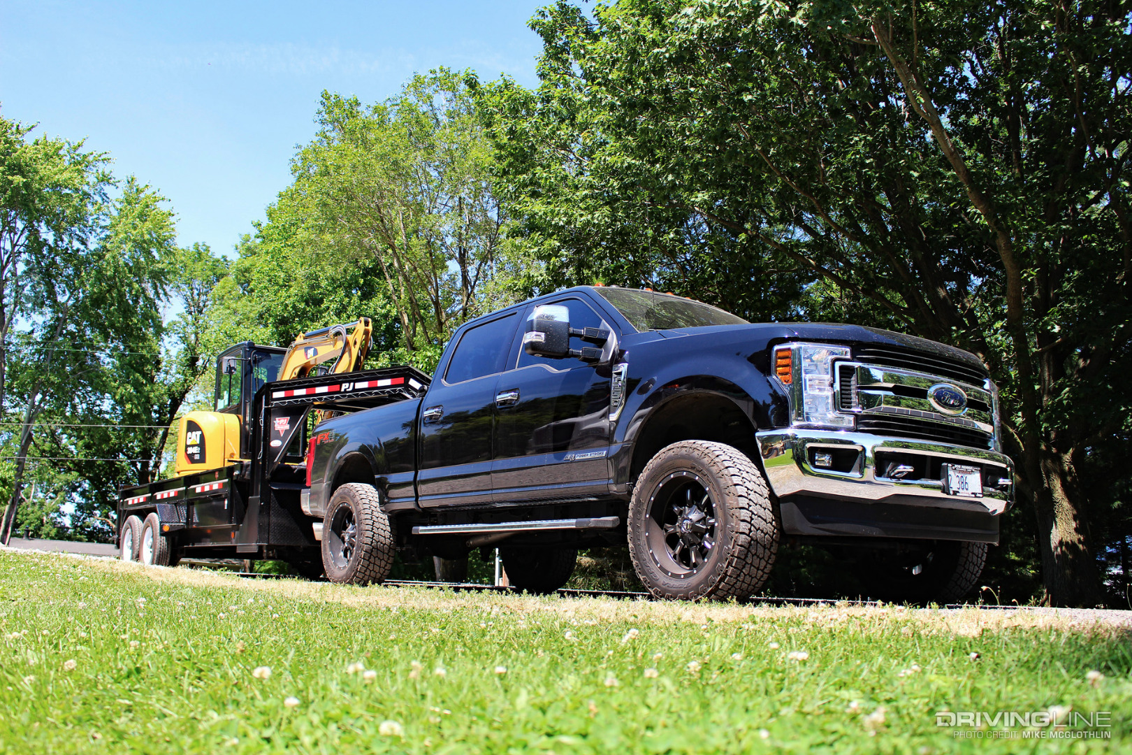 Ford Super Duty towing CAT digger
