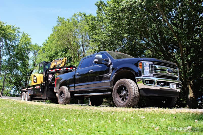 Ford Super Duty towing CAT digger