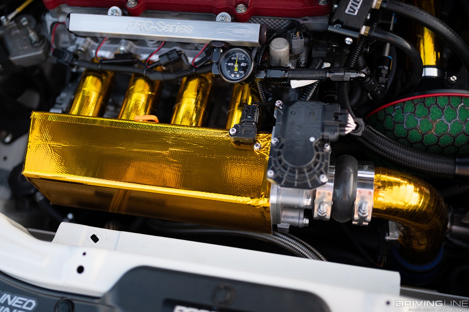 Mario Mojica Nitto Tire NT01 turbocharged Honda Fit custom Golden Eagle intake manifold and heat-reflective gold tape