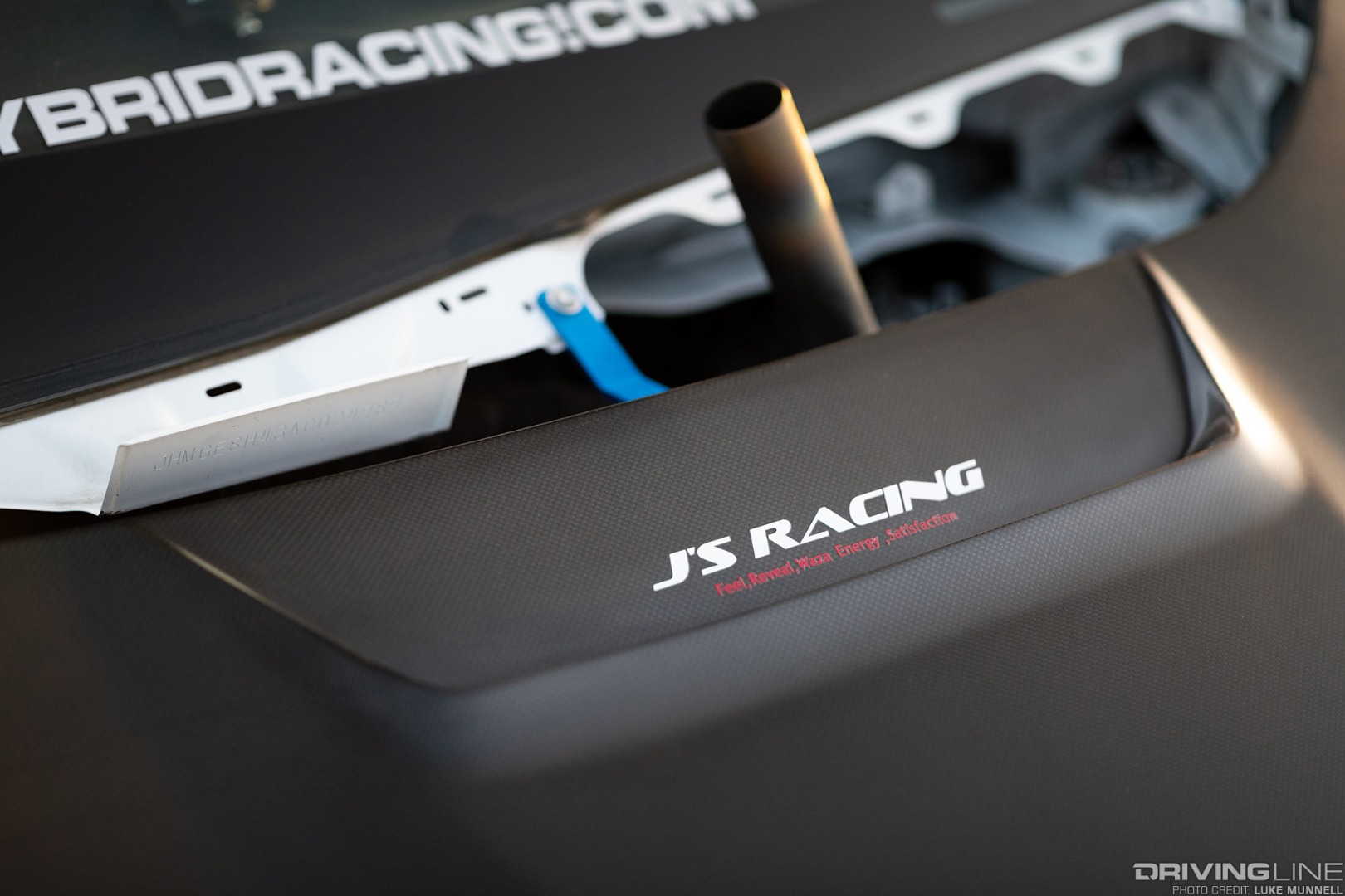 Mario Mojica Nitto Tire NT01 turbocharged Honda Fit closeup of J's Racing vented carbon fiber hood