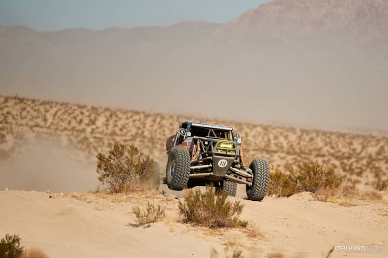 Bailey Cole driving his rig up over a berm