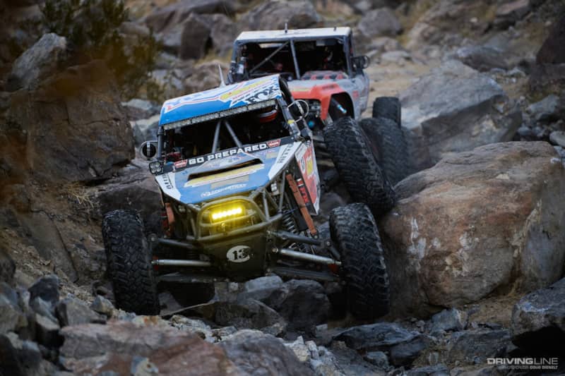 Bailey Cole and Loren Healy driving through the rocks